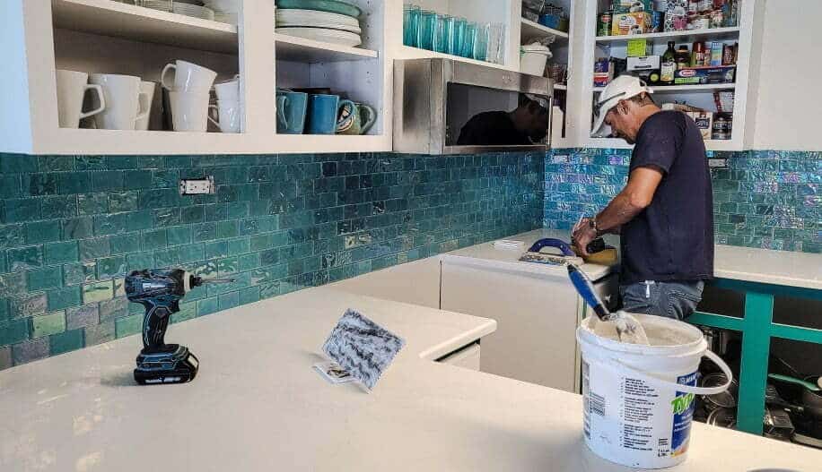 A handyman painting countertops, for article, how to paint countertops